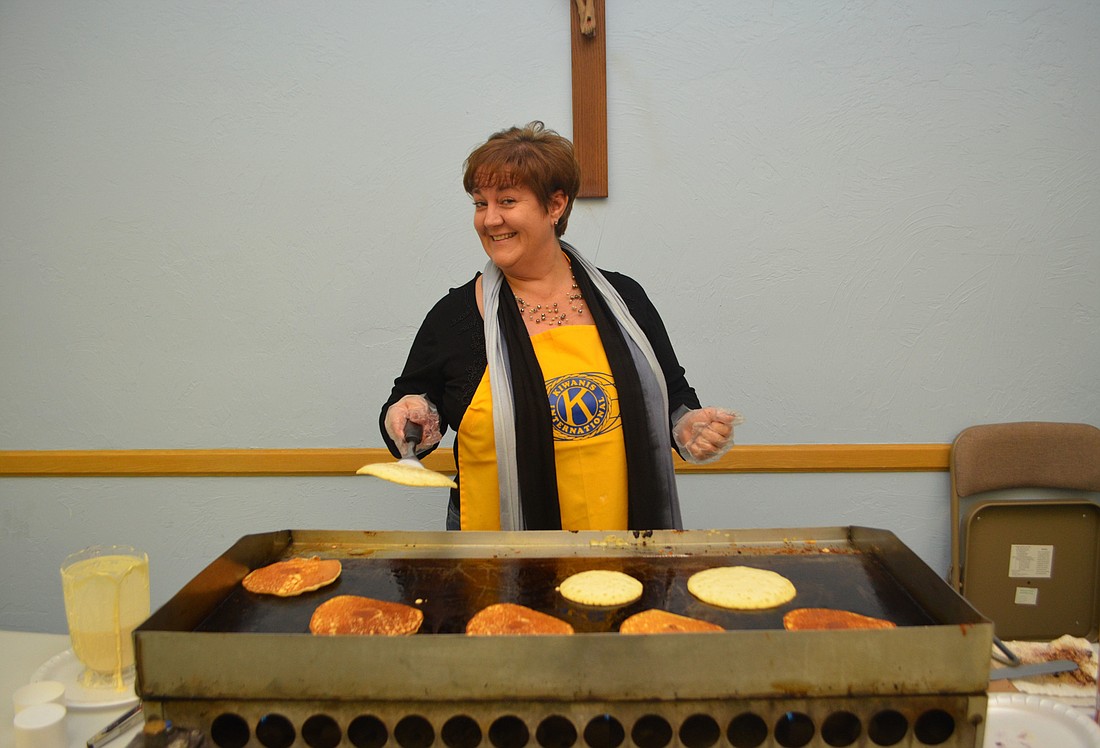 Riana Rawson flips pancakes at last year&#39;s breakfast.