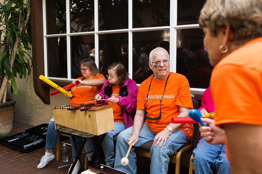 Paige, Amy and Steve play music for guests, accompanied by Beverly Boardman.