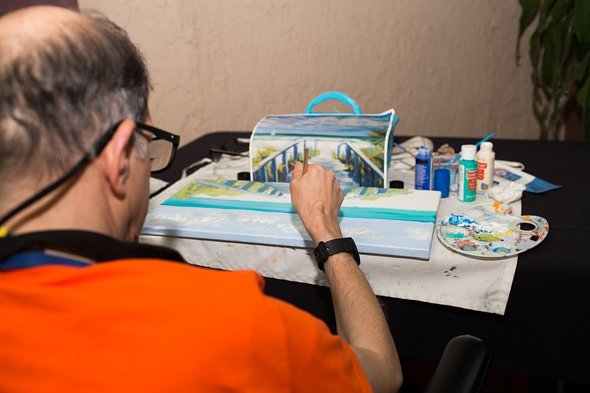 Gorge Barbados paints a seascape.