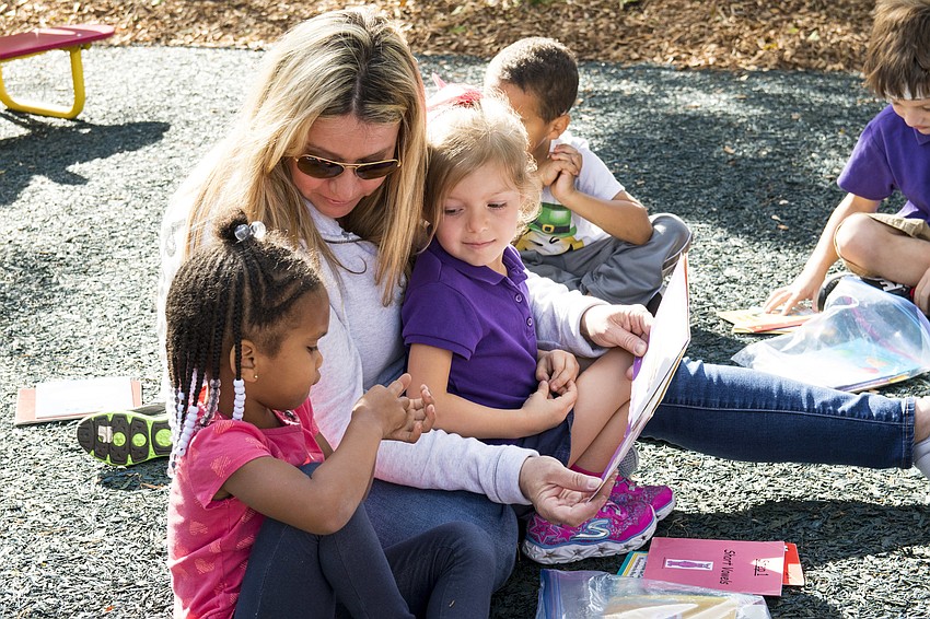 Sonya and Nikita Myer read with a preschooler from Children First.