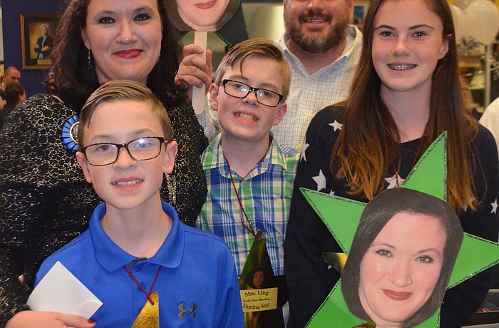 Carrie Ling with her family from left to right: Lawson Ling, Landen Ling, George Ling and Libby Ann Ling with their signs of support.