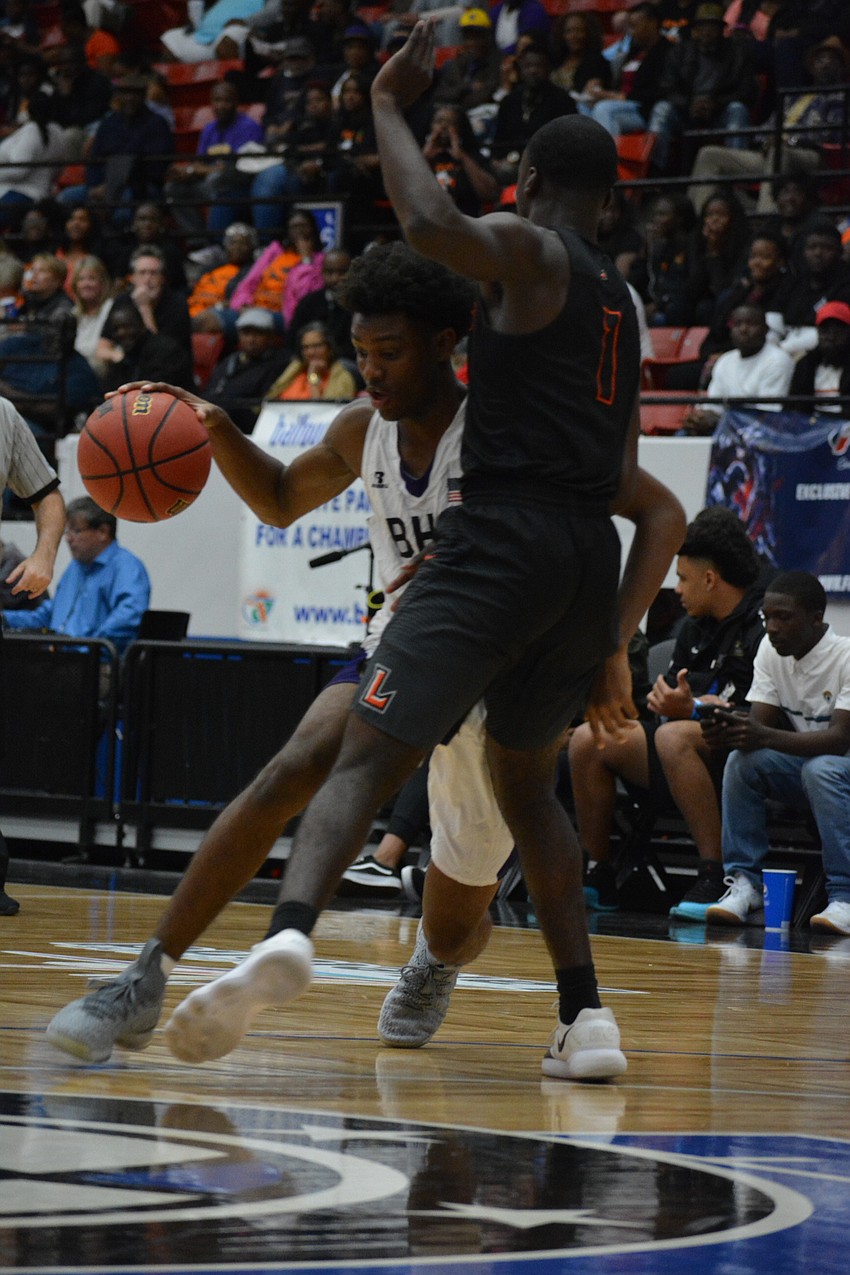 Jordan Clark bodies a Leesburg defender beyond the three-point line.