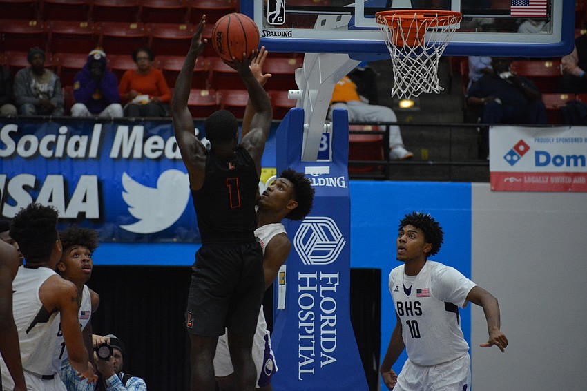 Jordan Clark contests a Leesburg shot.