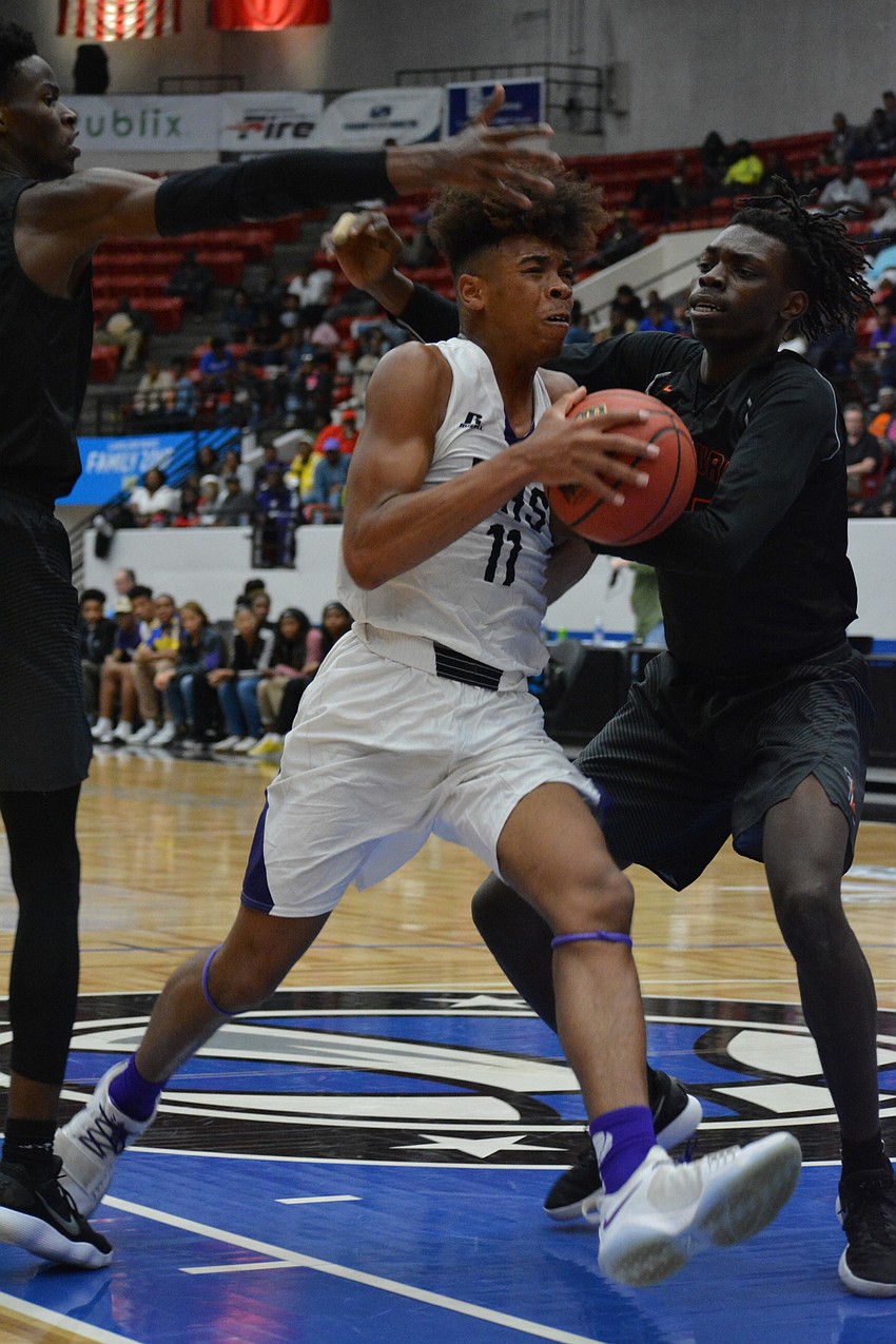 Johnnie Williams IV muscles his way into the post for a layup.