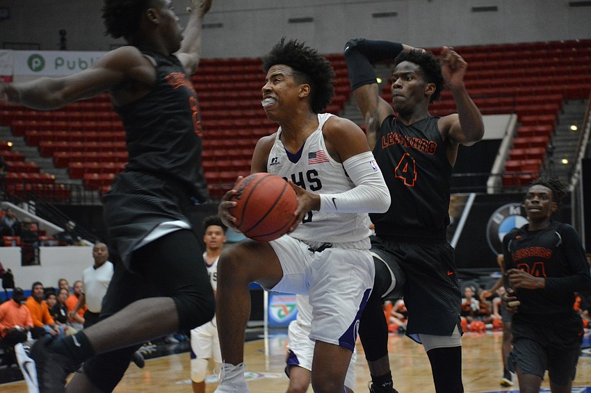 Jaylen Jones contorts his body on a layup attempt.
