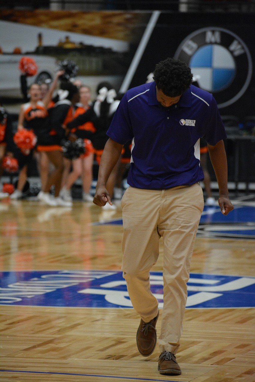 Booker coach Markus Black walks off the court following the one-point loss.