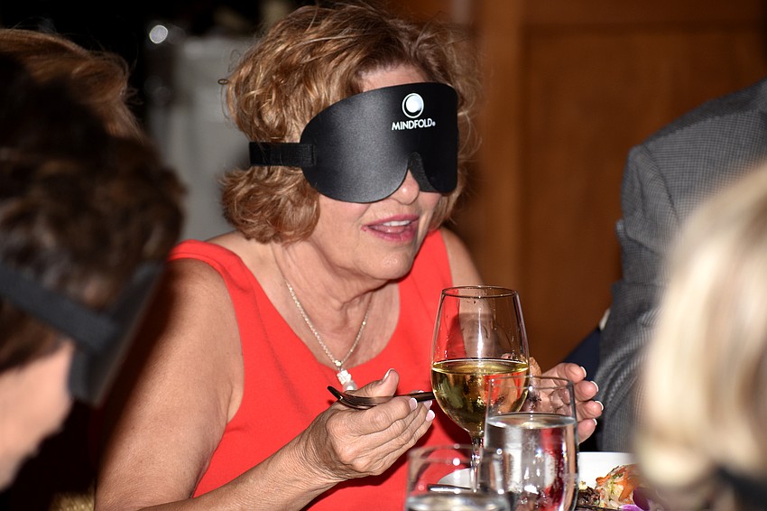 Colleen Richard attempts to eat her food while blindfolded.