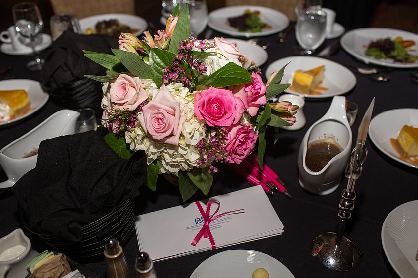 The floral arrangements were provided by Beneva Flowers & Plantscapes.