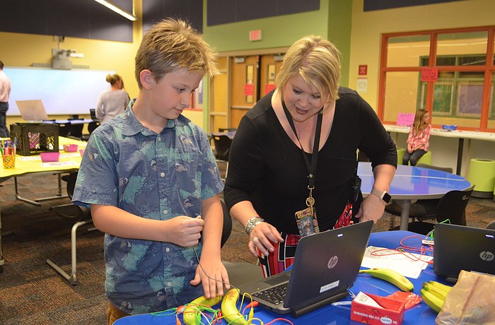Third-grader Quinn Kaffold and his teacher Carolyn Winget play the "Banana Bongos" at McNeal's STEAM night.