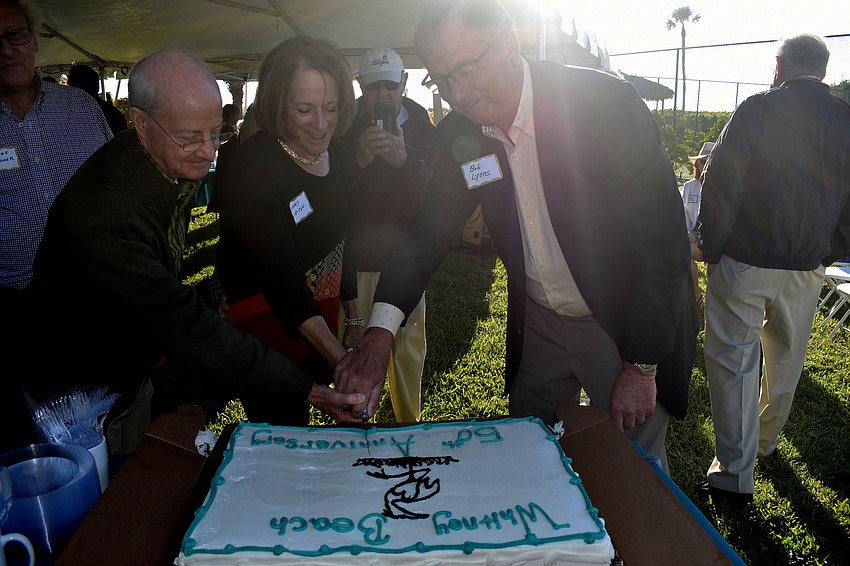 Former Whitney Beach Condominium Association presidents Jack Crain and Ginny Lipton cut the cake with current President Bob Lyons.