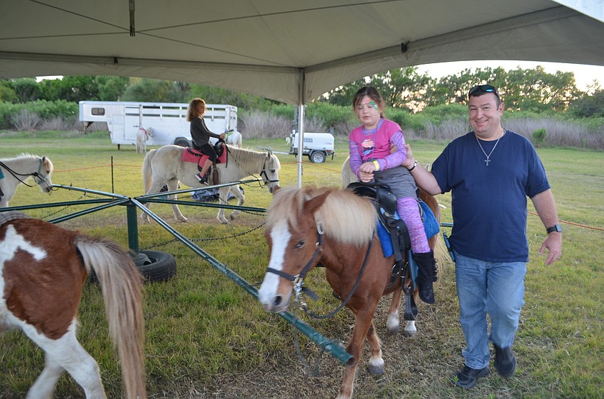 Cape Coral's Michaela Ward, with her dad, Donnie, chose a pony ride over a hot air balloon ride.