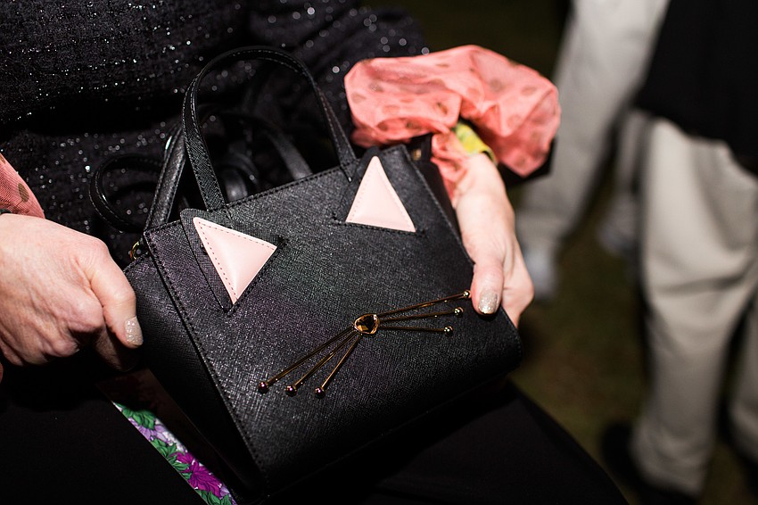 Linda Slavin carries a cat purse.