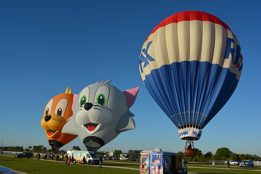 Tom and Jerry balloons join a RE/MAX balloon at the Sarasota Balloon Festival.