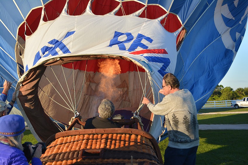 Pilot Fred Vereb of Tampa fires up the air in his balloon.
