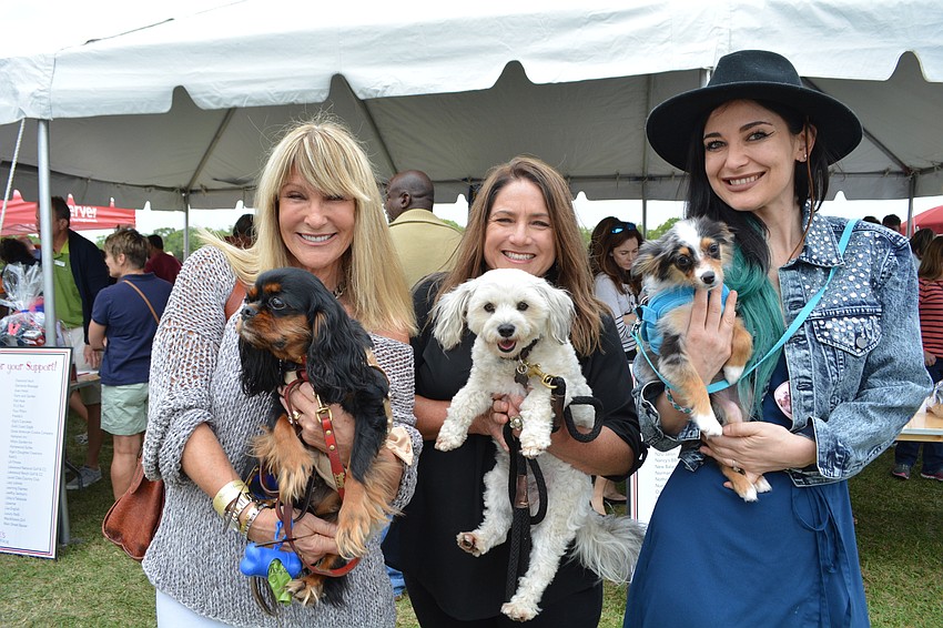 Sarasota's Lynn Barrie spends the day with her daughters, Jaymie Klauber and Zara Barrie. They hold their dogs, Edie, Robbie and Luka (left to right).