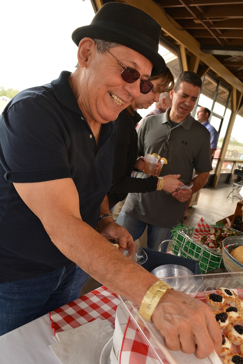 Sarasota's Tony Cervantes samples a lemon curd cup. It's his first time to the event.