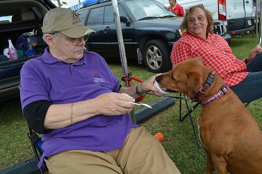 Lakewood Ranch's Bob Swiatek gives his dog  Tanner a taste of ice cream as his wife, Patricia, watches.