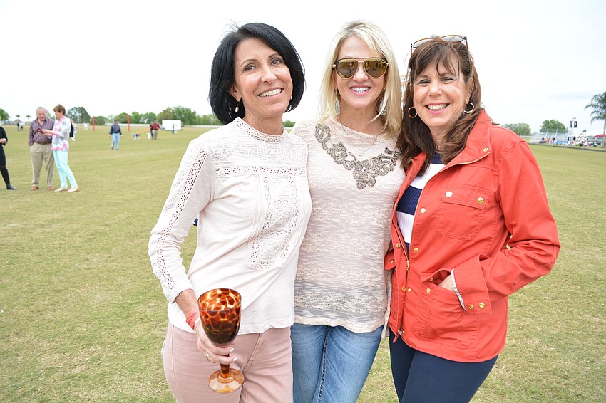 East County residents Christine Mazur, Stacy Tocci and Reeny Kaney make sure to hunt for divots during halftime.