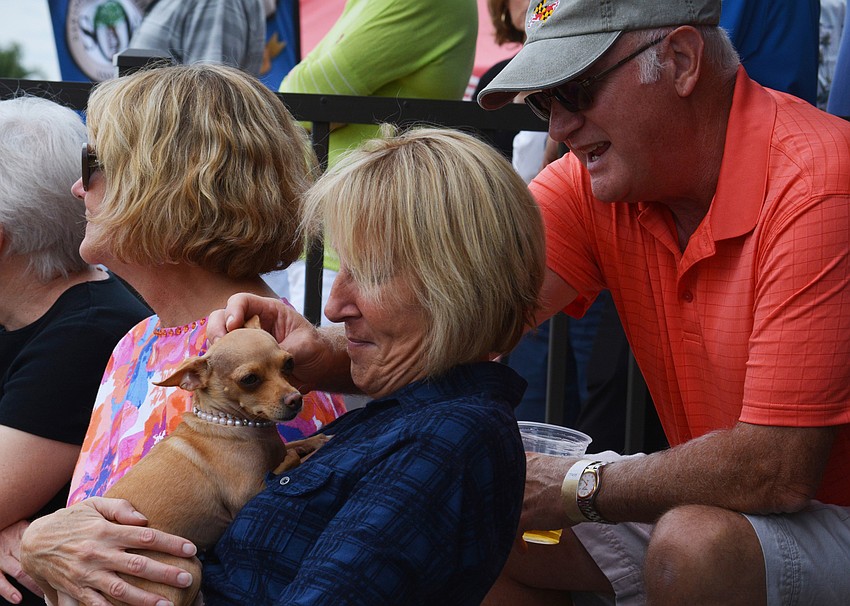 Jackie Bartley, pictured with Bill Eberhart, snuggles with Chica, owned by Monica Cervantes.