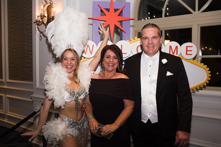 Greg and Tina Bliss pose with a Vegas showgirl.