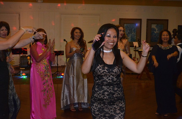 Sarasota's Nancy Wagner, an Asian Women's Club member, stepped into the middle of the dance circle created during the Orchid Ball. Photo by Amelia Hanks.