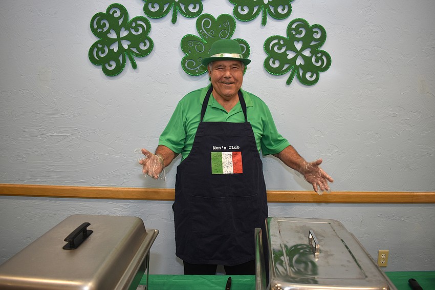 Joe Zampino gets ready to serve food.