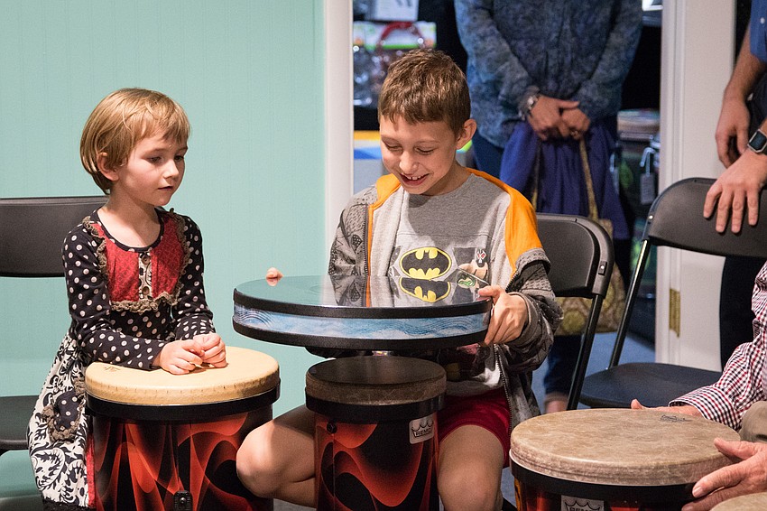 Oz Poppe and Harvey Wiggins have fun with an ocean drum, a drum made to sound like water rolling over the shore.