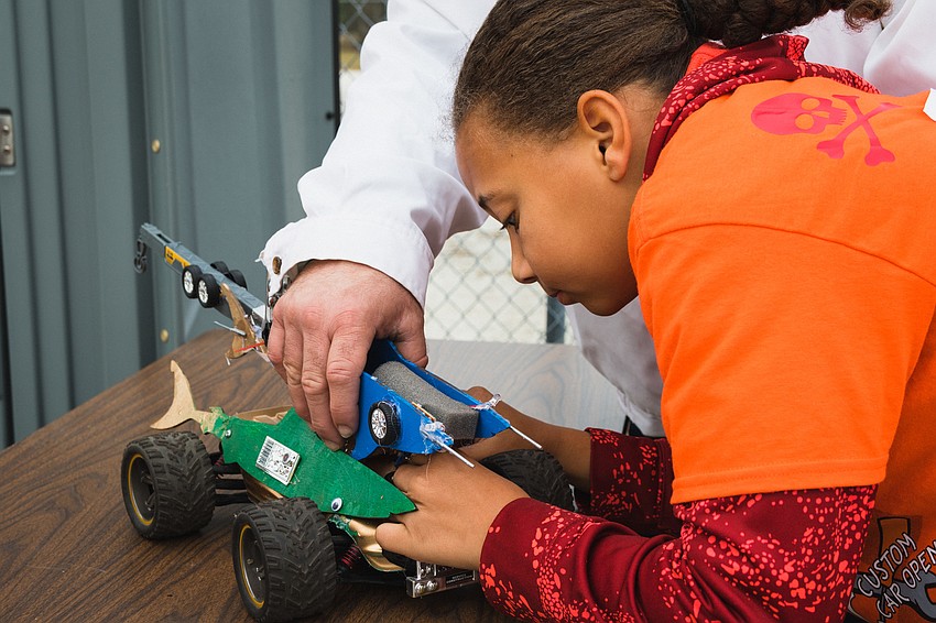 Luke Hars adds some finishing touches to his team's car.