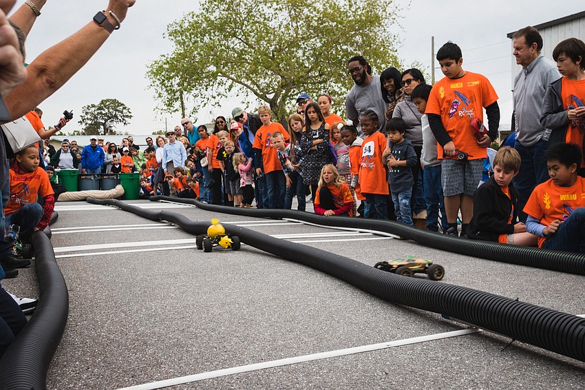 Spectators watch one of the first drag races of the event.