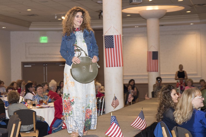 Melpomene Afstralou models a jean jacket, dress and handbag from Anthropologie.
