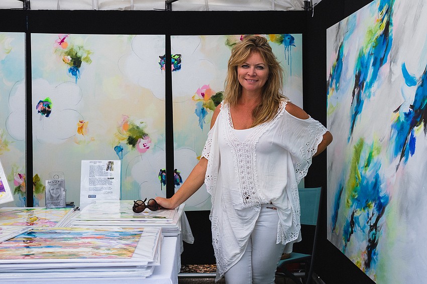 Joni Sarah White with her abstract acrylic paintings