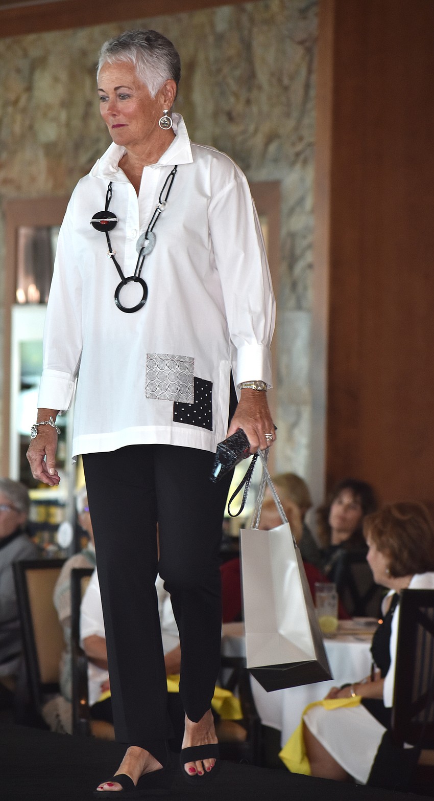 Pat Dupps smiles at her friends as she walks the runway.