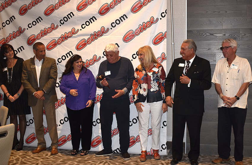 The previous chairmen and women pass the gavel to new chairman Mike Meador.