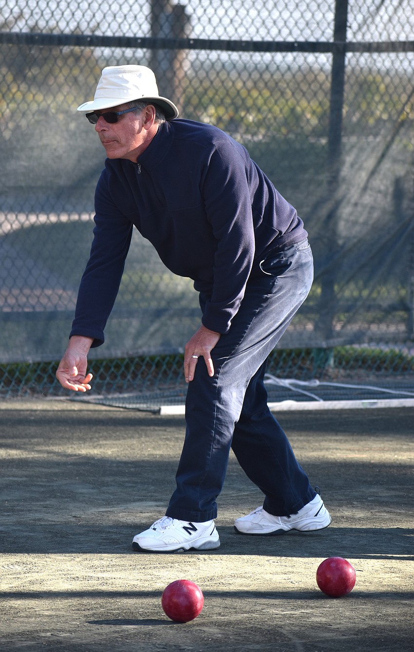 Gerald Daly watches as his ball rolls toward the pallino.