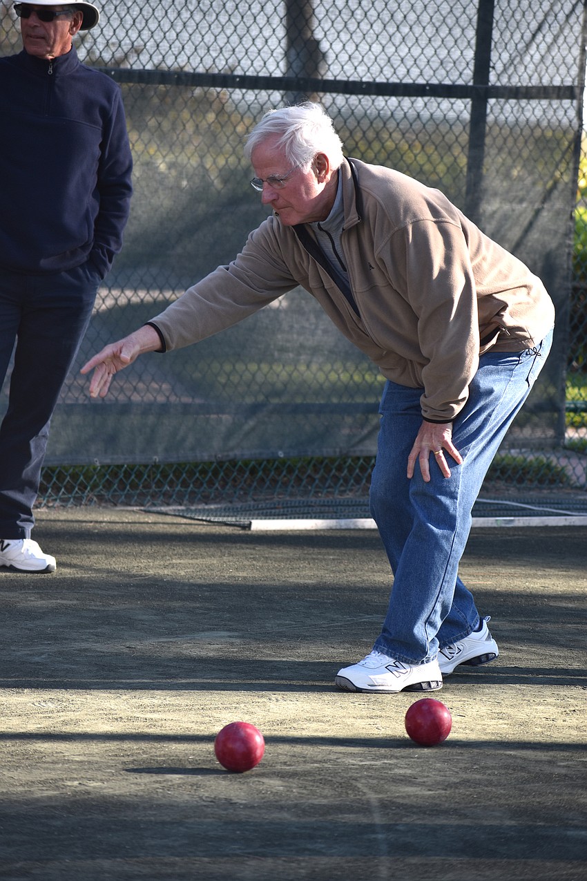 Charles Muntan releases the ball toward the pallino.