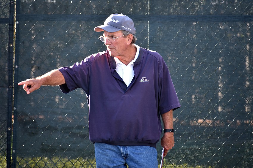 Jerry Digani, who organizes the tournament, scores the ladies’ bracket of the tournament.