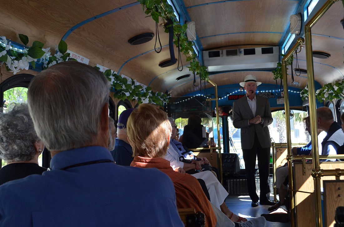 Harold Bubil addresses the audience at the beginning of a March 8 trolley tour, which focused on standout