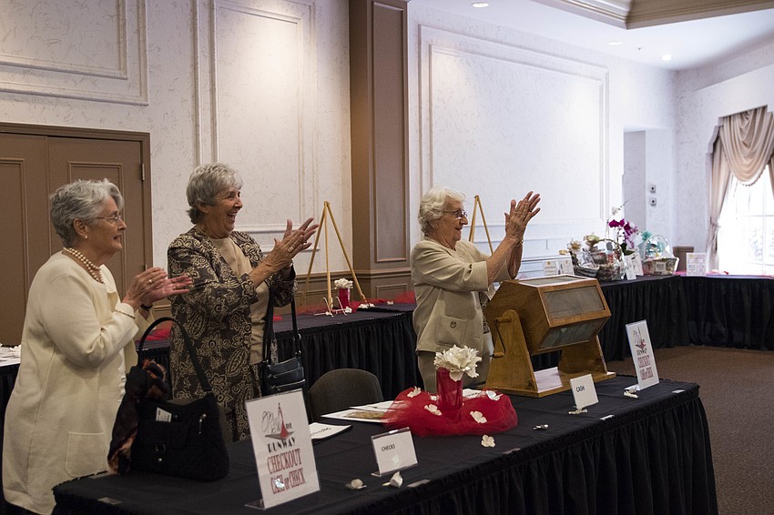 Women's Guild members reveal raffle winners.