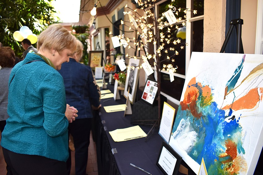 Joan Emrich peruses silent auction items.