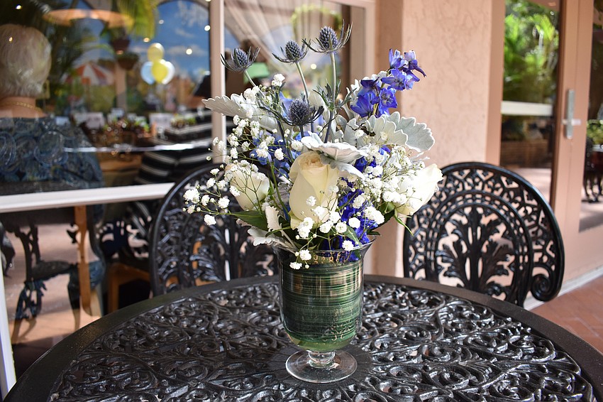 Floral touches spilled out into the atrium in the event colors of blue and soft yellow.