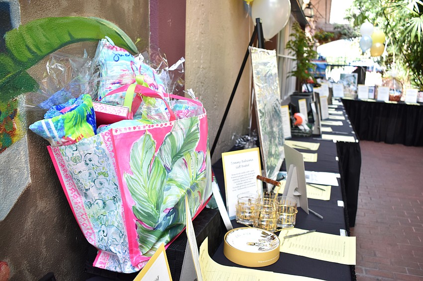 Auction items such as a Lilly Pulitzer-themed bag filled the atrium.