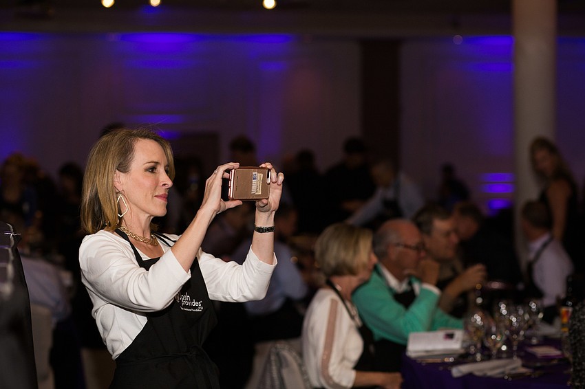 Cyndi Edwards takes a video of the event on her cell phone.