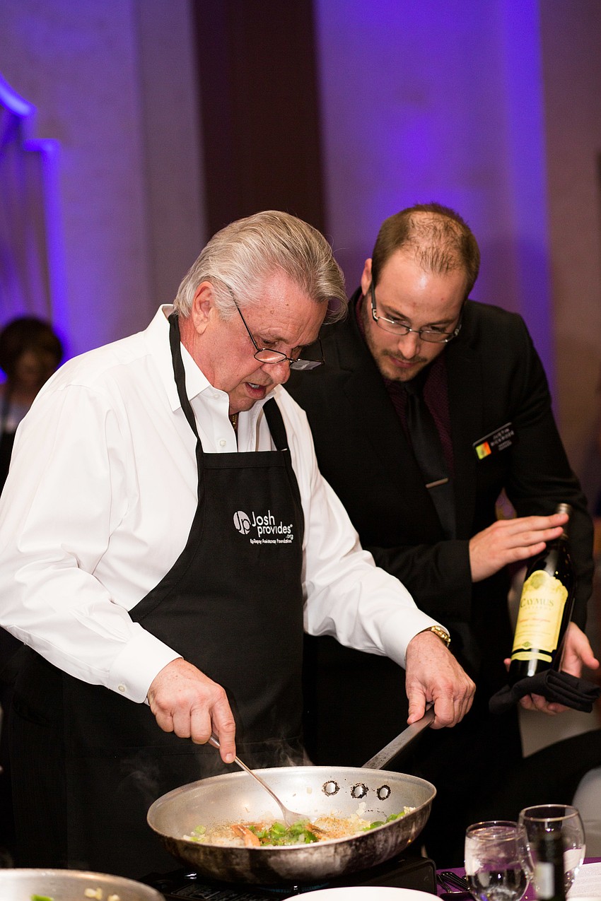 Ron Milton prepares the dish while picking out a wine.