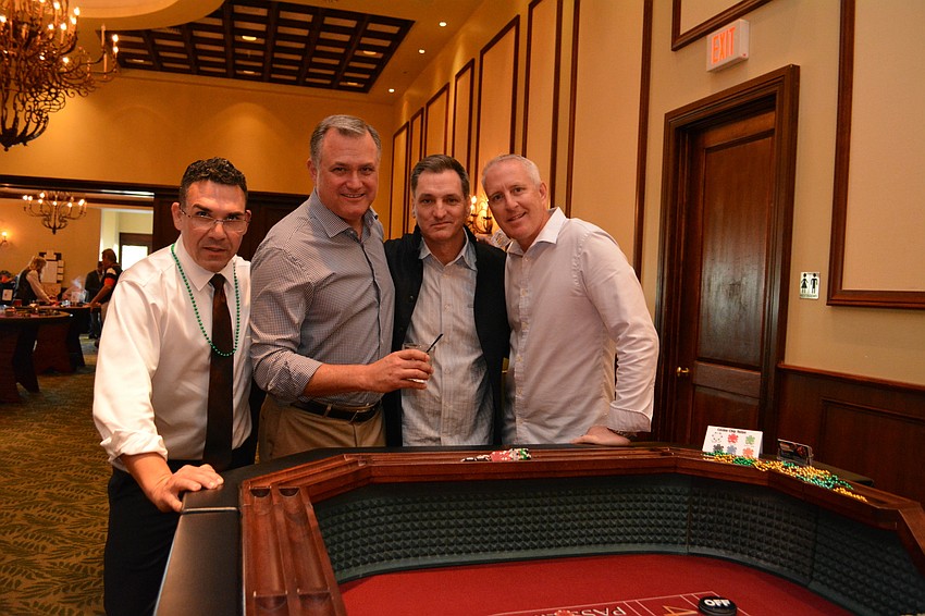 Tracey Demino, Andy Busby, Mike Shaklik and Dan Jordan try to win craps.