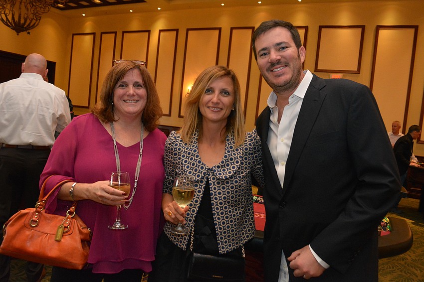 Debra Robertson mingles with Michela Baratta and her husband, Lucien Ducrey.