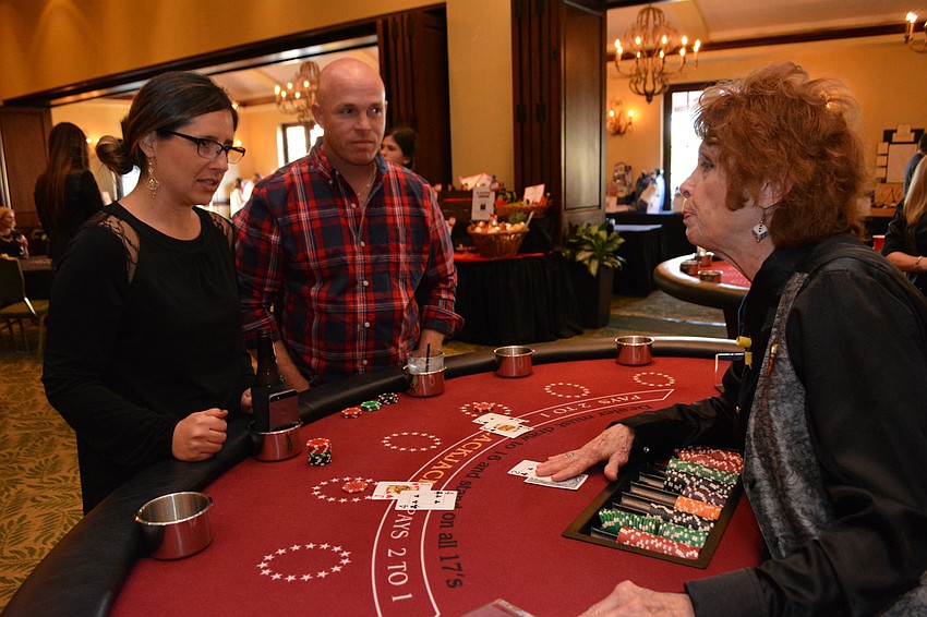 Willis teacher Diana Grigsby and her husband, Tim,  are dealt by Carolyn Branco.