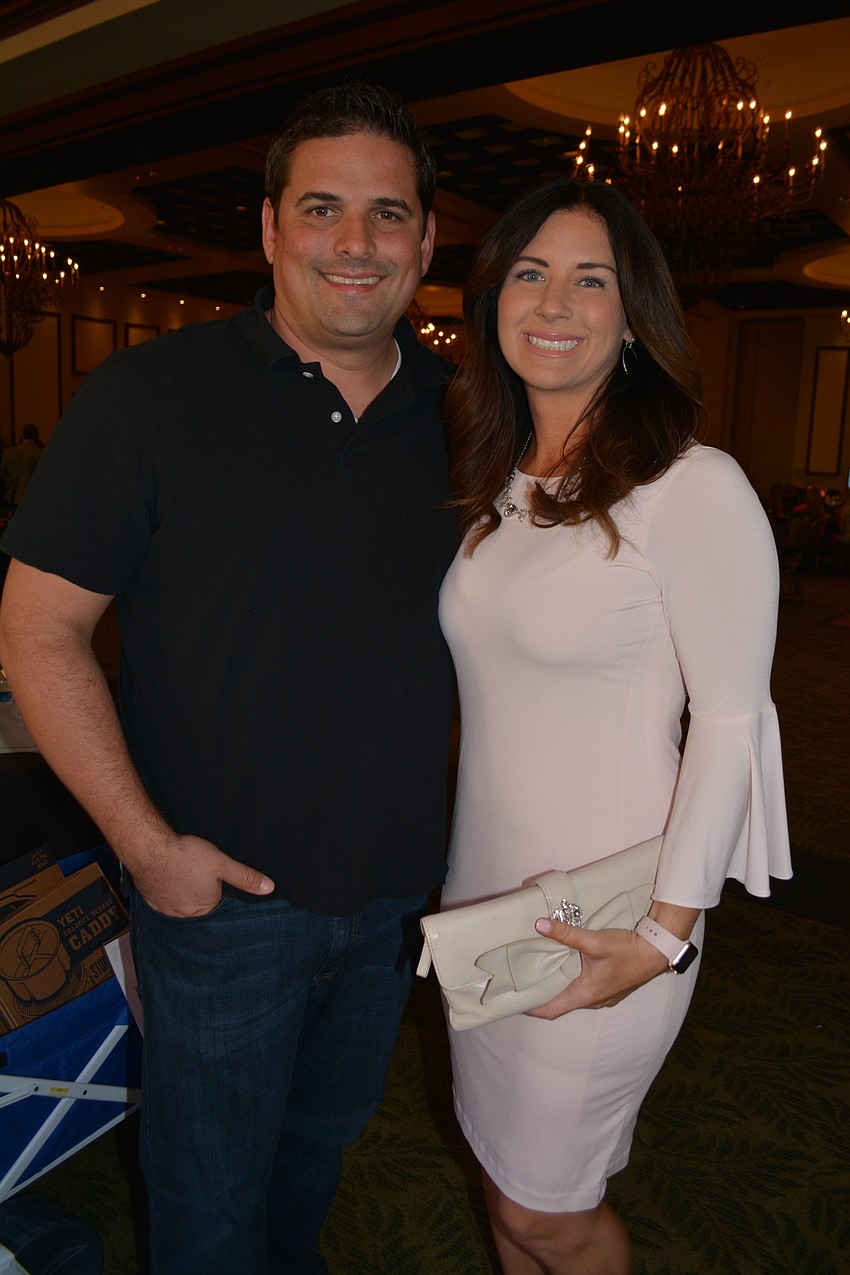Michael and Schuyler Galliano check out the silent auction items.
