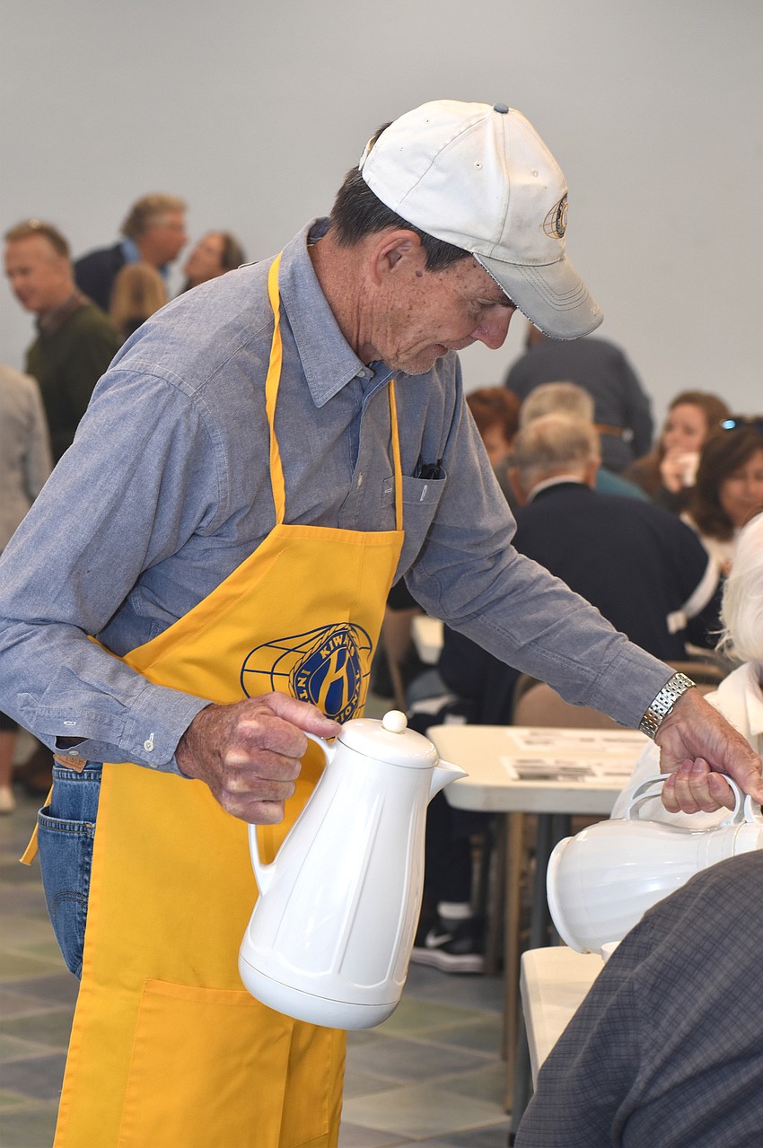 Jim Larson serves coffee to attendees.