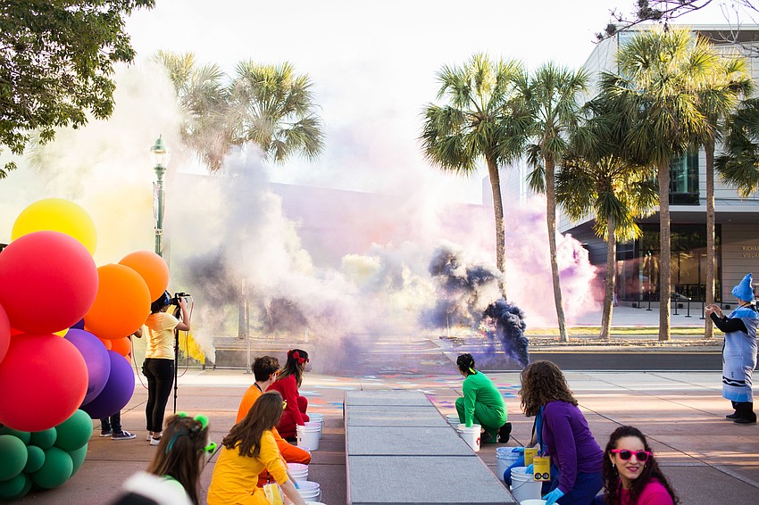 Just before Ringling College President Larry and Pat Thompson arrived, colorful smoke bombs clouded the road.