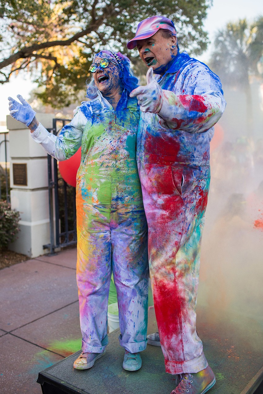 The Thompsons' outfits went from white to splattered with different color.